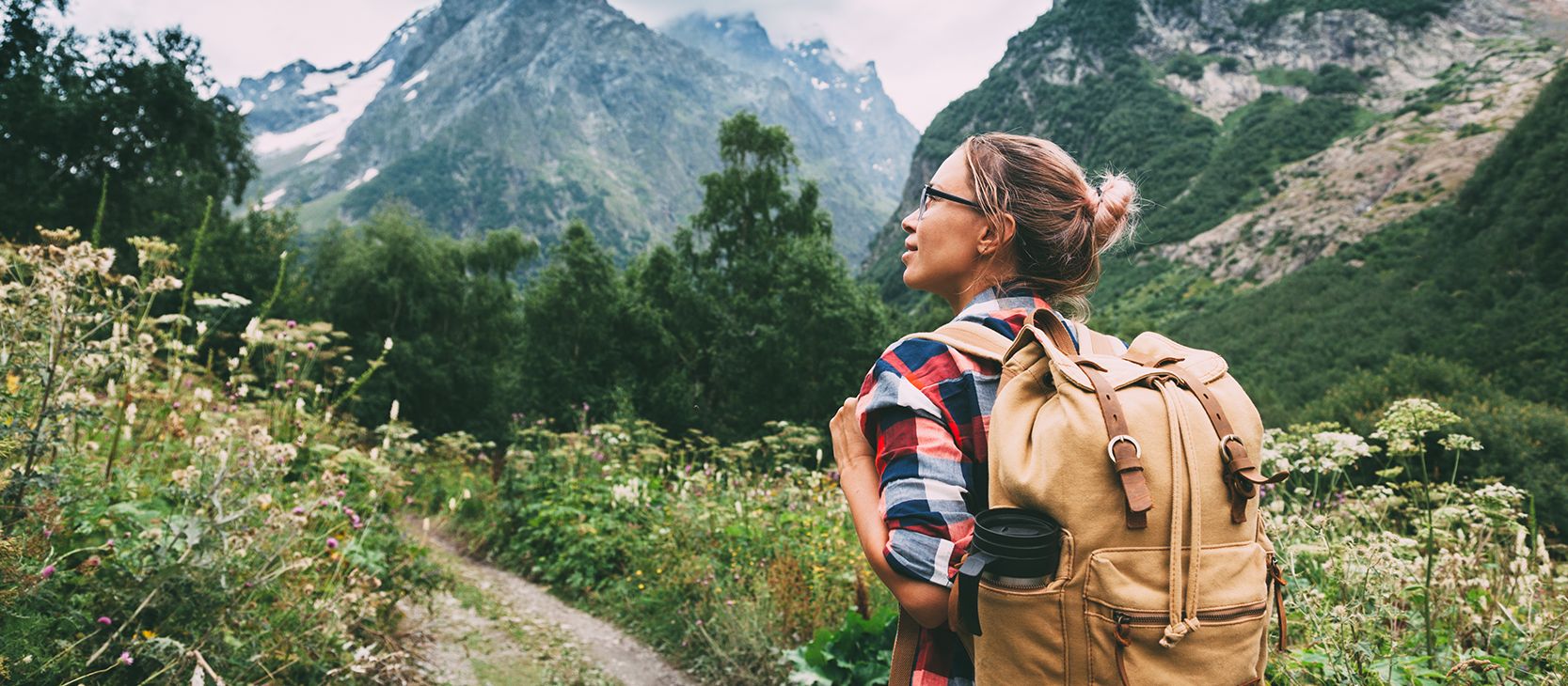 Woman escaping her worries by traveling in a beautiful mountain region