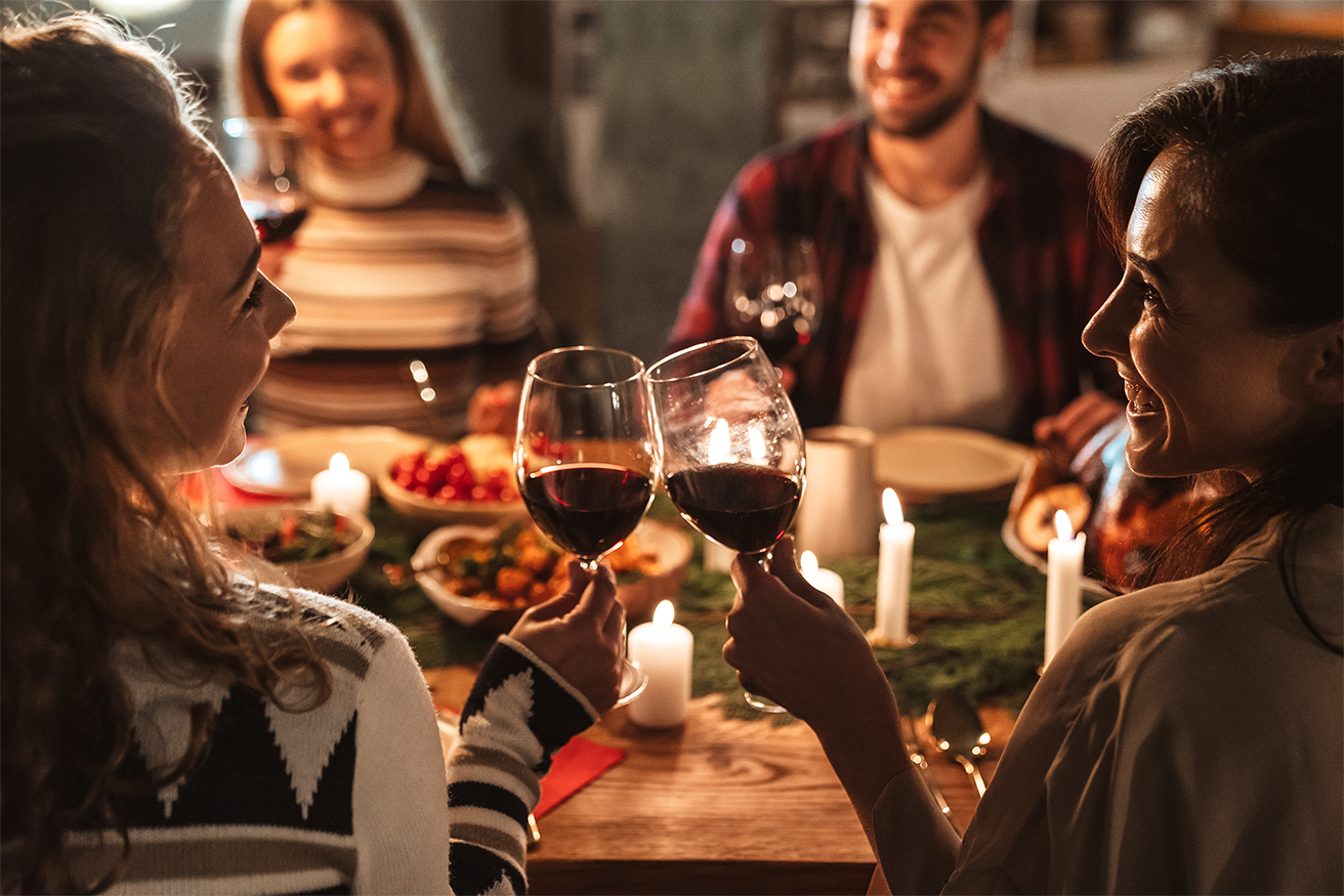 People at a holiday table toasting