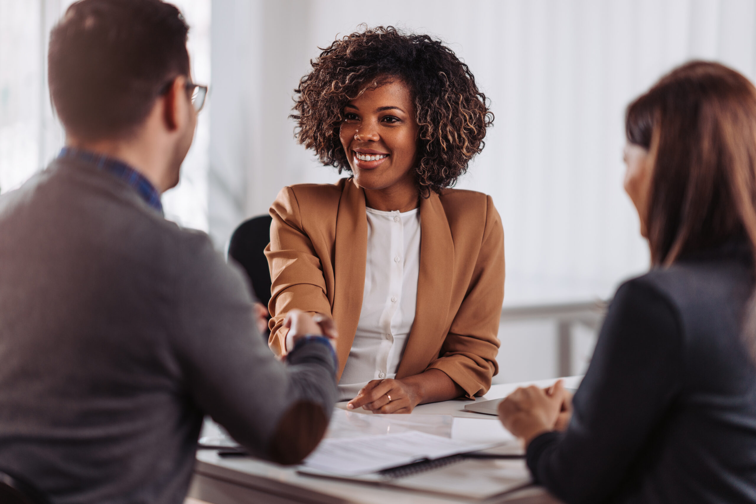 Business people shaking hands after meeting Financial advisor giving good advice to clients and gaining their trust at the bank